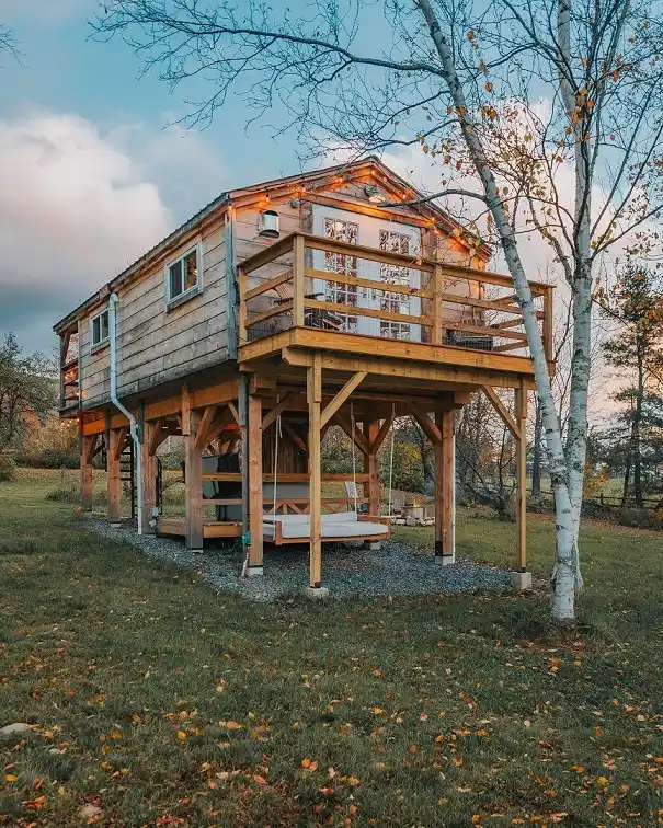 12. Elevated Cabin on Timber Posts with a Hanging Daybed