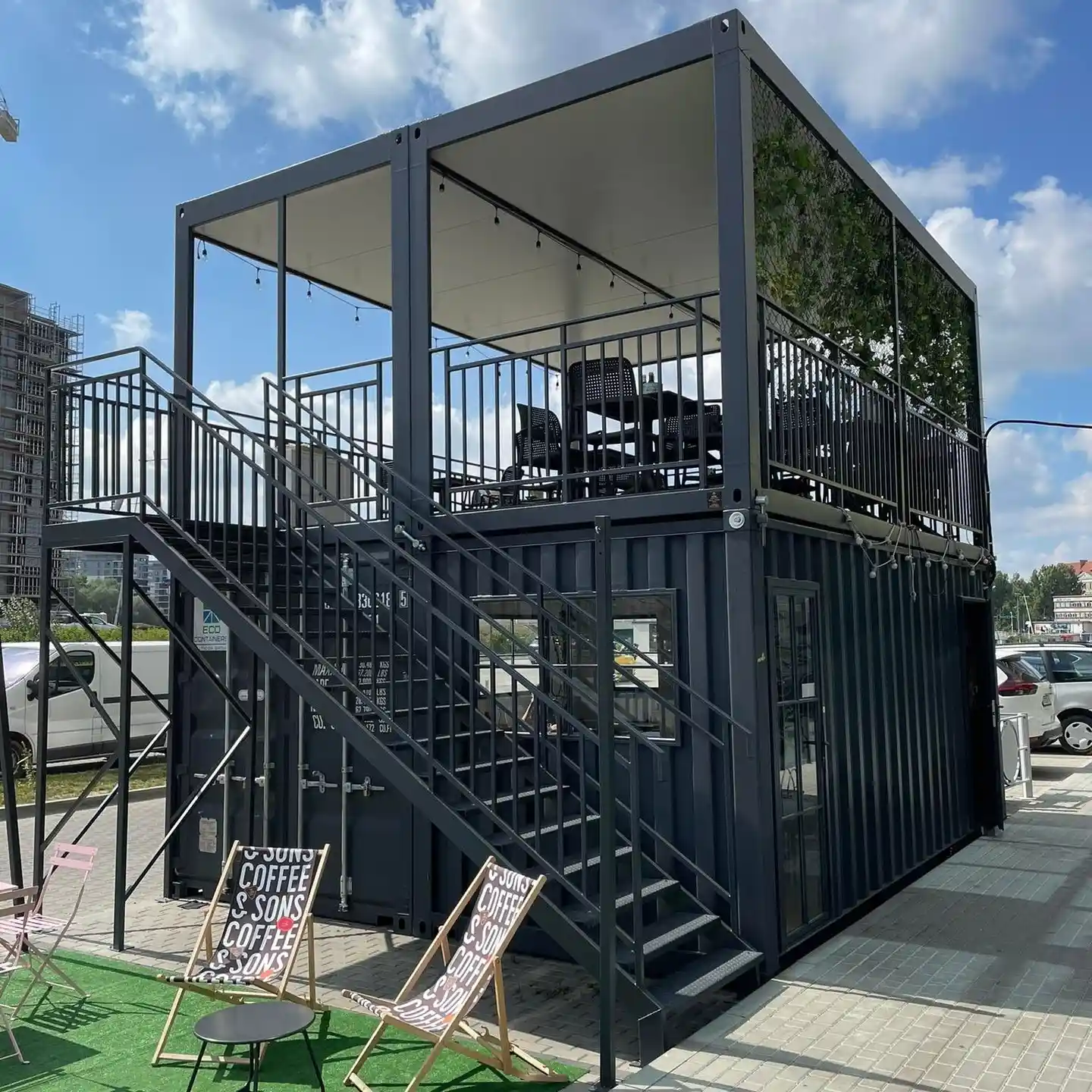 5. Two Level Black Container Café with an Open Rooftop Terrace