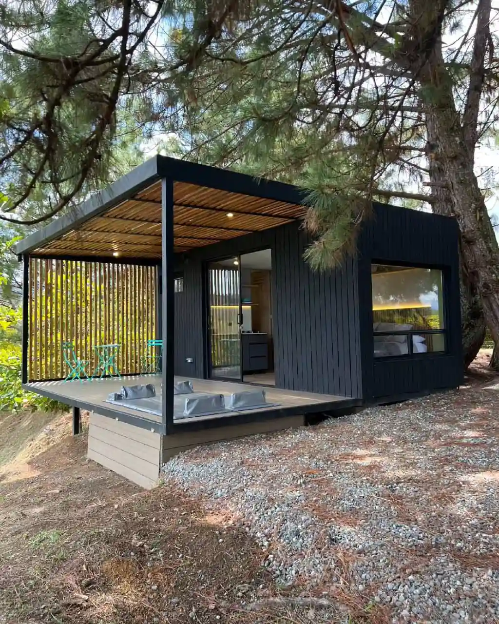 1. Black Container Cabin with a Covered Deck