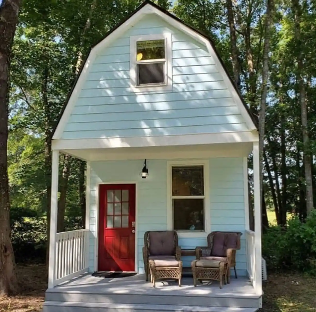 15 Tiny House Ideas for Couples Who Live Small Full-Time 14 13. Sky Blue Siding and a Red Door Under a Gambrel Roof