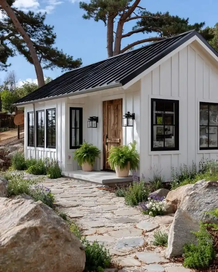 1. White Board and Batten Tiny House with Black Metal Roof
