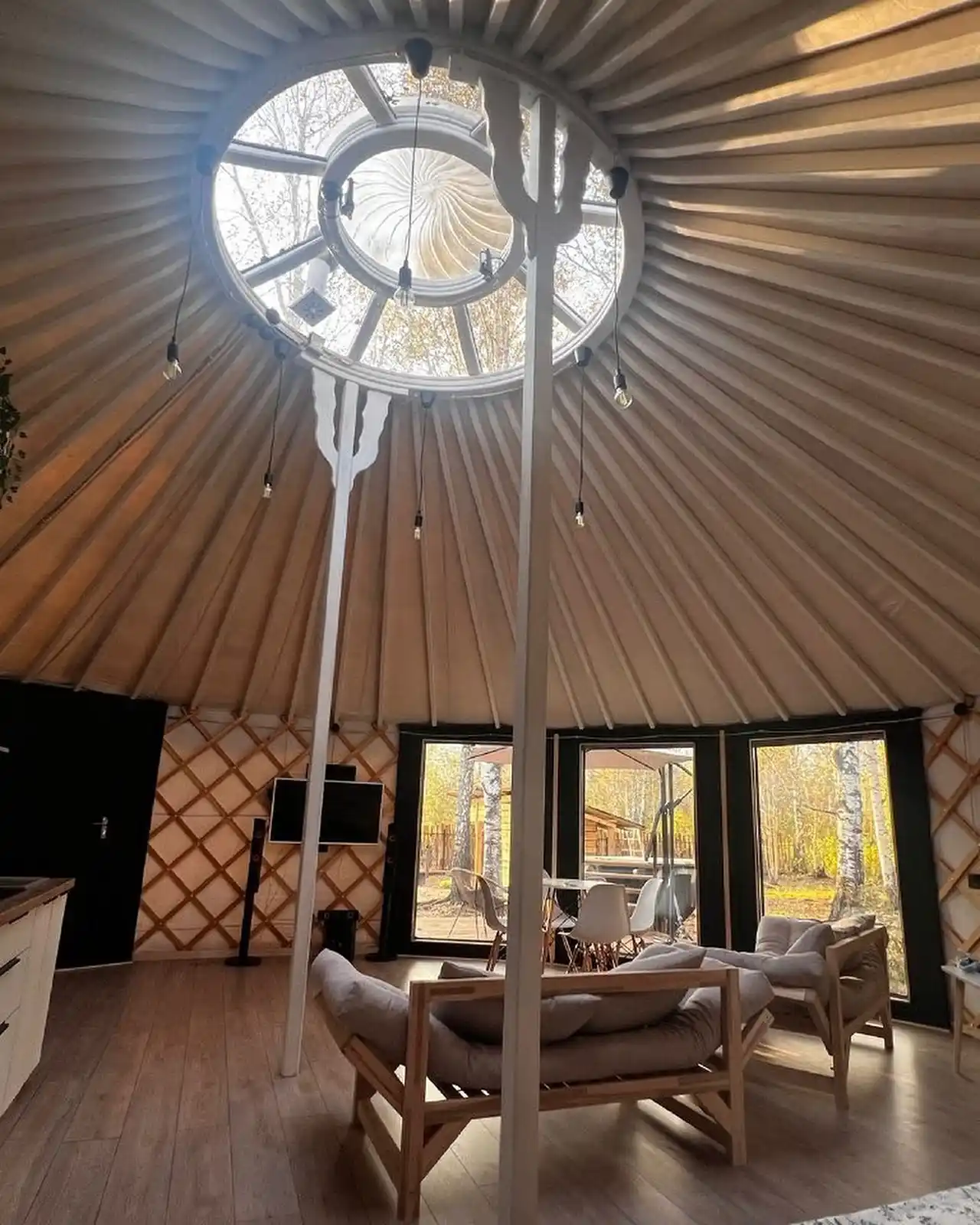 17 Yurt Living Ideas for a Cozy Off-Grid Lifestyle 5 4. A Skylight Ring and Bare Bulbs Over a Low Lounge