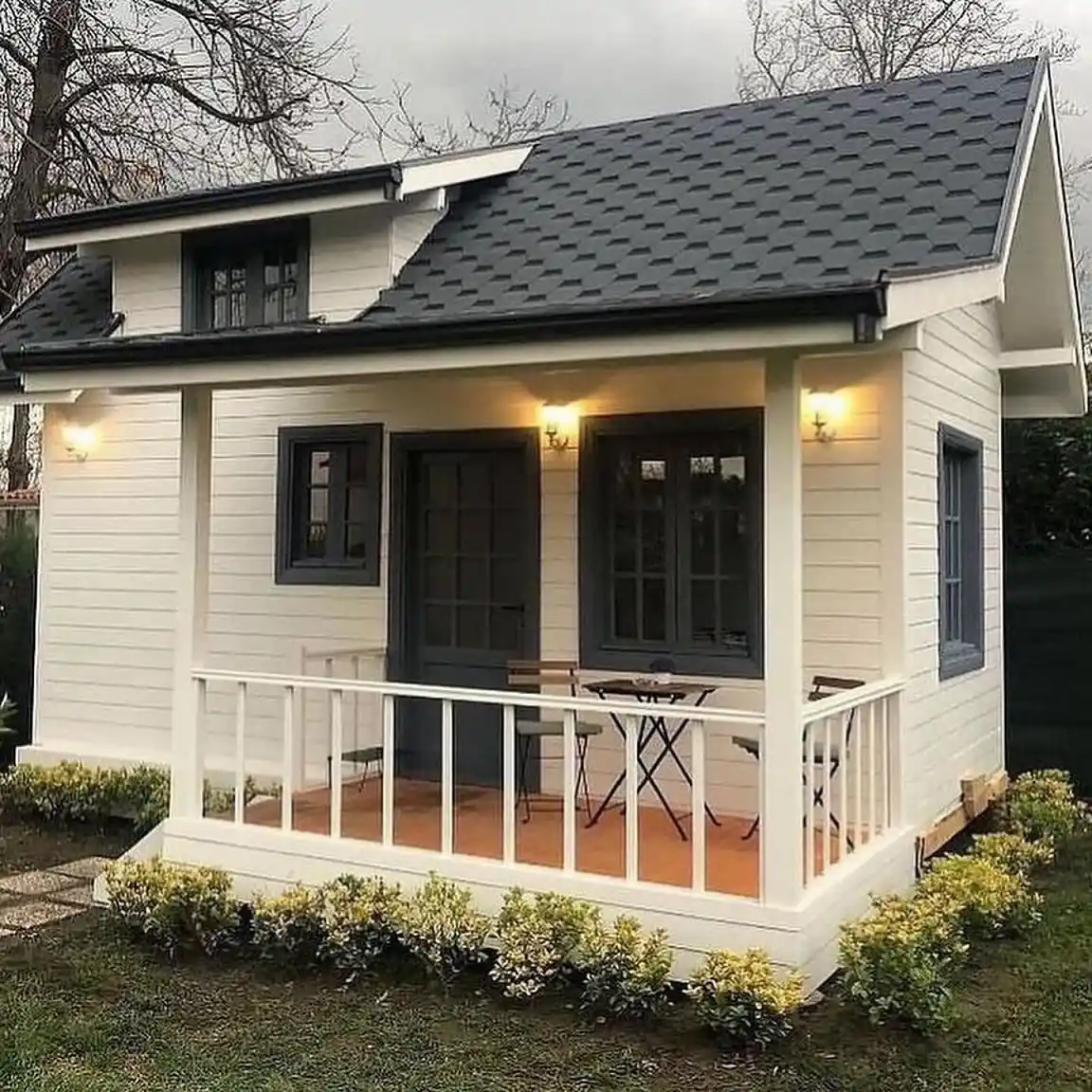 15. Cream Cabin with a Slate Roof and Dark Trim