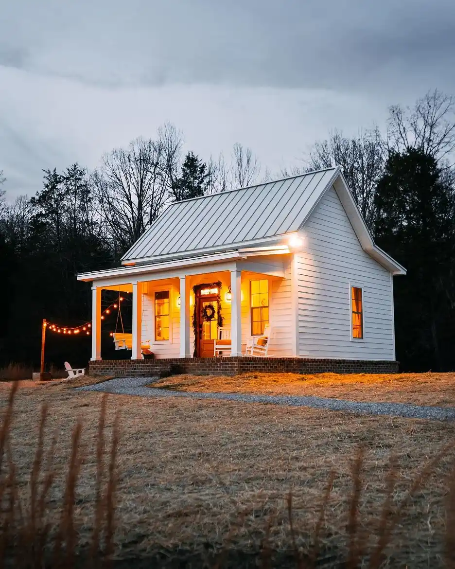 1. White Cottage with a Glowing Front Porch