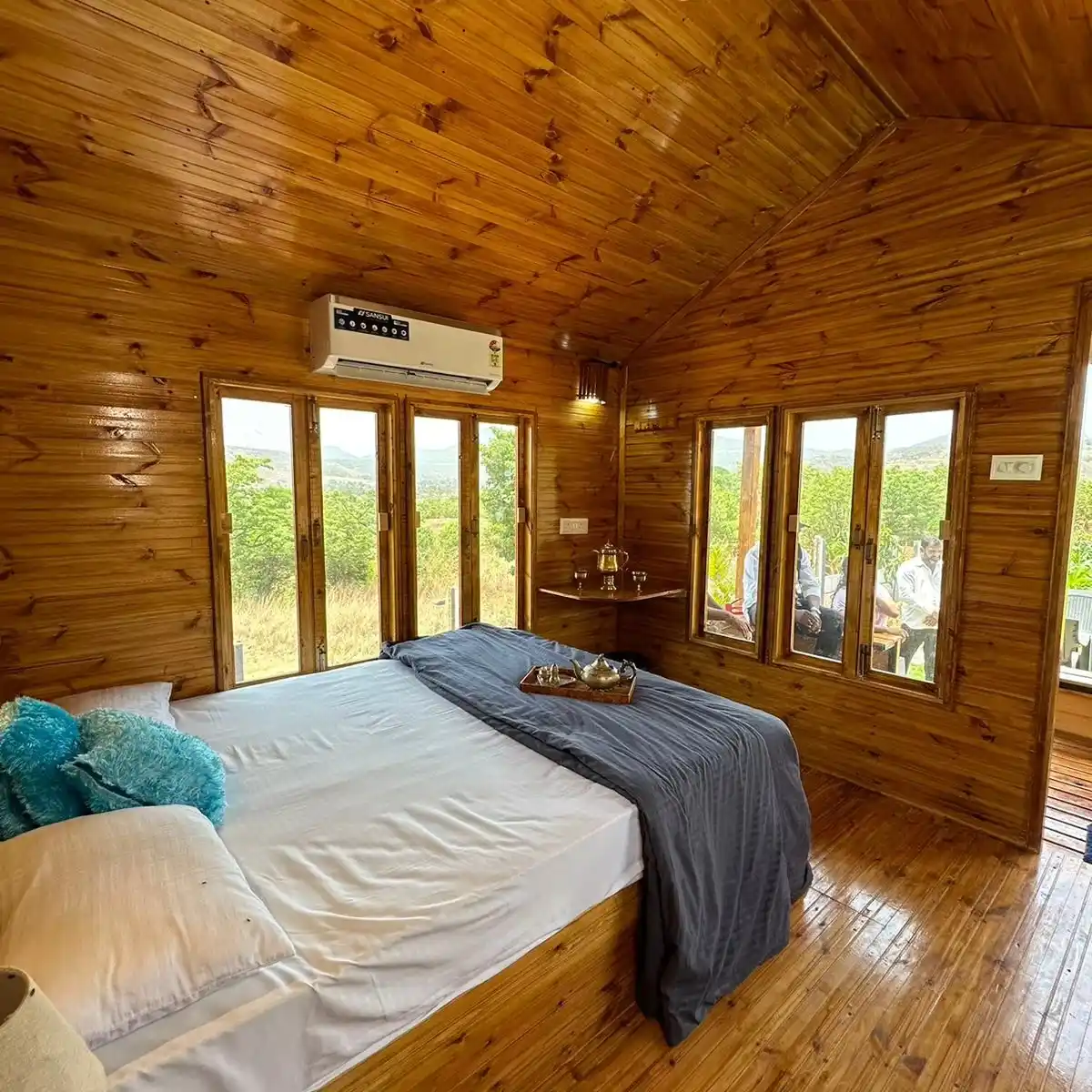 13. Knotty Pine Cabin Bedroom with Hillside Windows