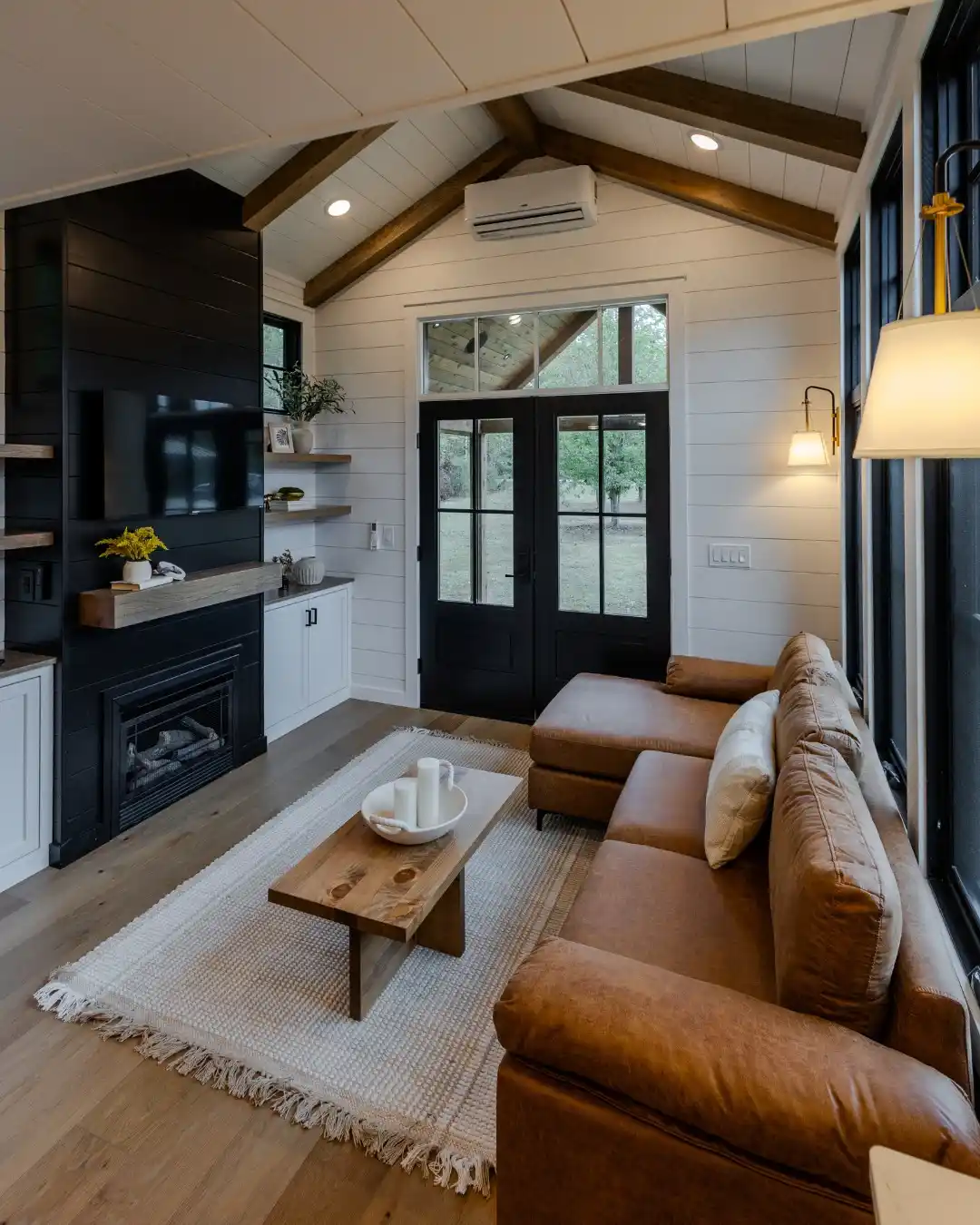 7. Black Fireplace Wall and Caramel Leather
