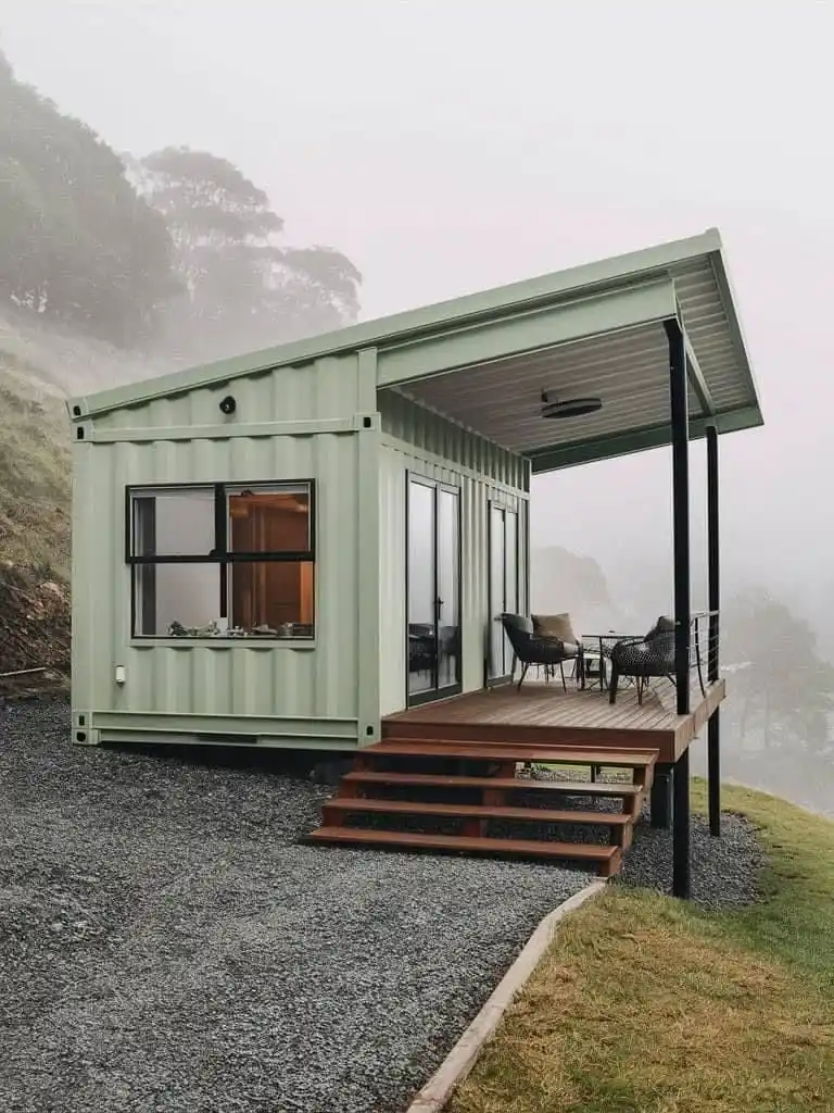 11. Pale Green Container Home with a Sloped Roof