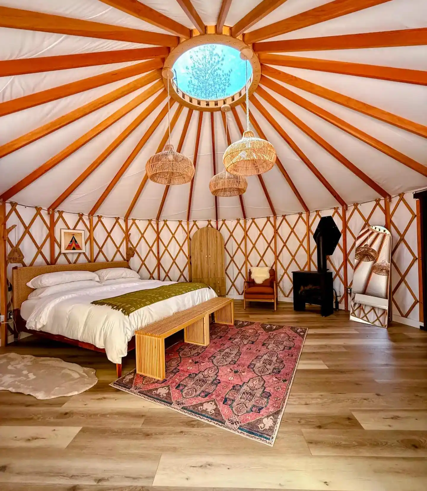 17 Yurt Living Ideas for a Cozy Off-Grid Lifestyle 9 8. Rattan Pendants Over a Pink Vintage Rug