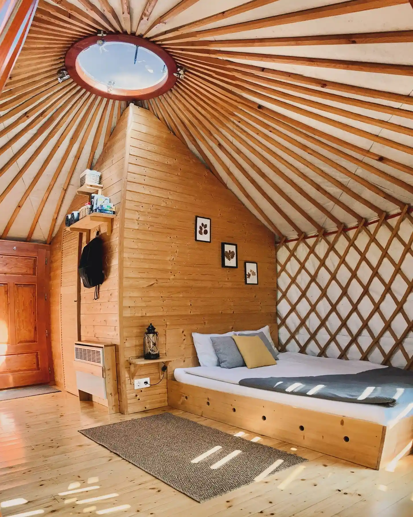 17 Yurt Living Ideas for a Cozy Off-Grid Lifestyle 12 11. A Pine Platform Bed With Wall Shelves