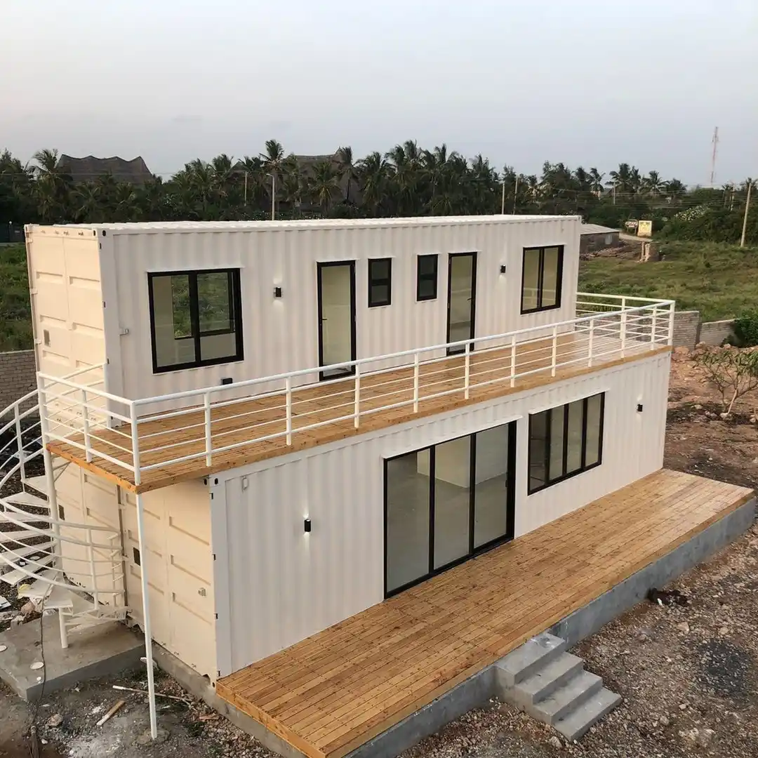 6. Cream White Stacked Container Home with a Spiral Staircase