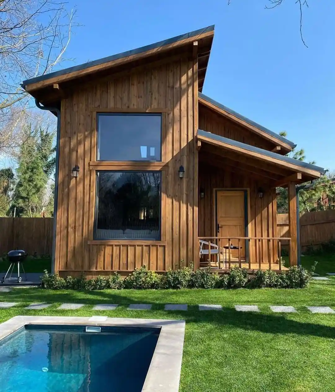 6. Honey Wood Cabin with a Tall Window Wall