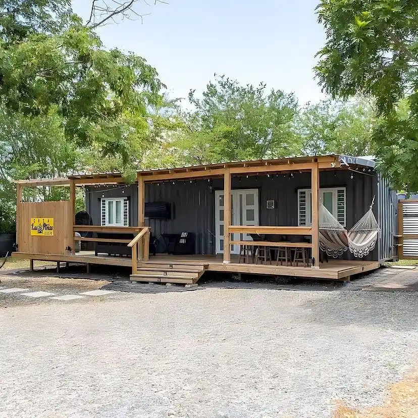 9. Charcoal Container Home with a Hammock Porch
