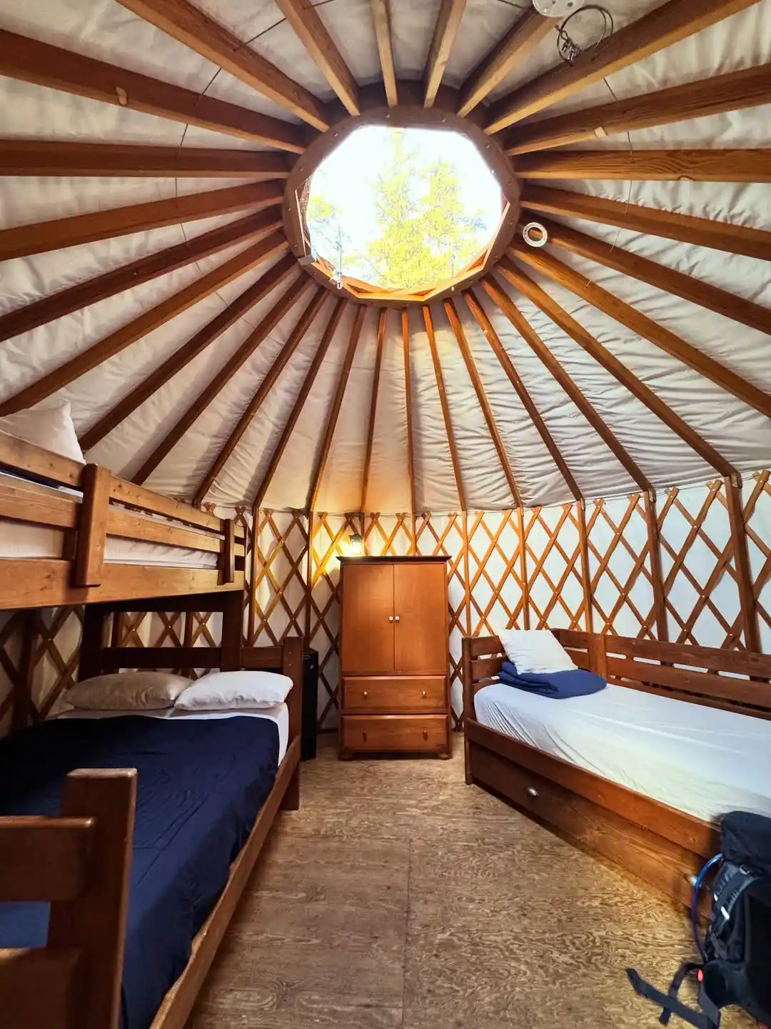 17 Yurt Living Ideas for a Cozy Off-Grid Lifestyle 15 14. Bunks, a Daybed, and One Tall Armoire