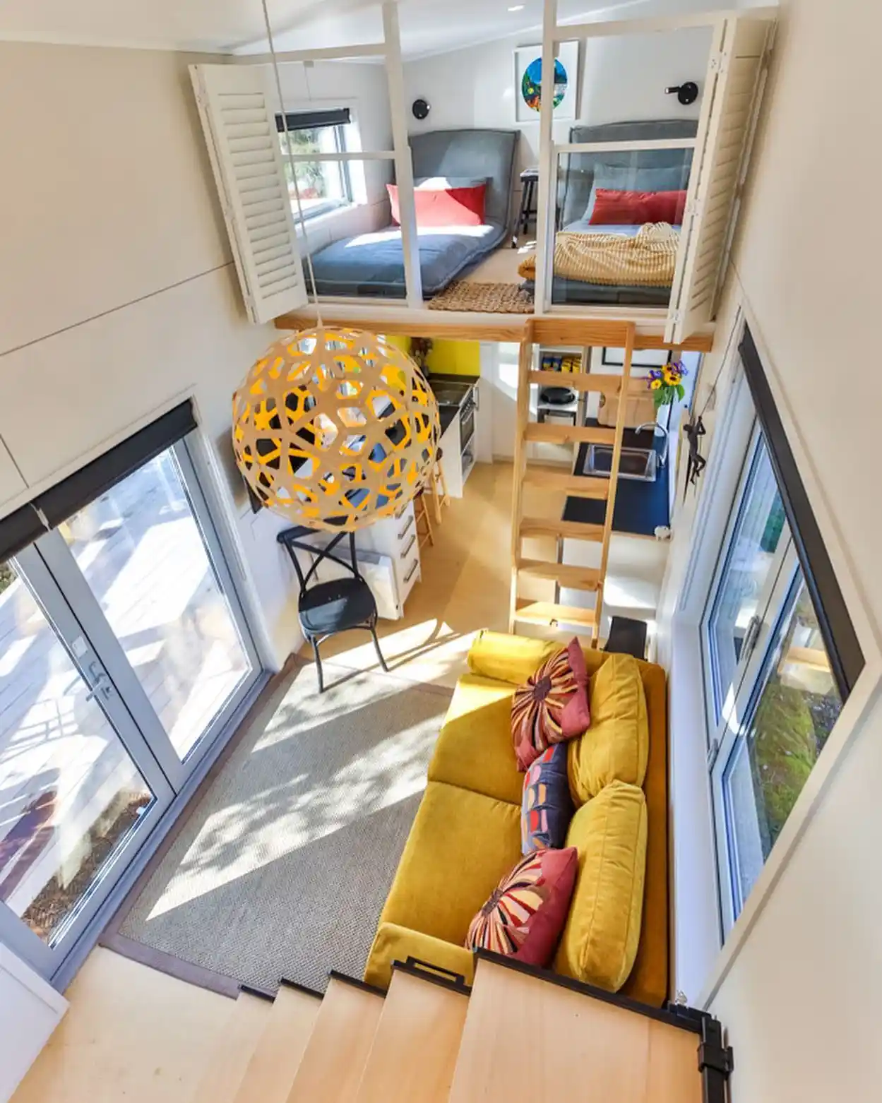 15 Tiny House Ideas for Couples Who Live Small Full-Time 6 5. Sunlit Loft Bedroom Above a Mustard Sofa