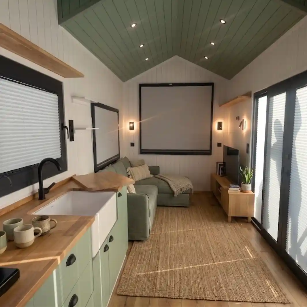 15 Tiny House Ideas for Couples Who Live Small Full-Time 11 10. Sage Green Ceiling, Cabinets, and a Jute Rug