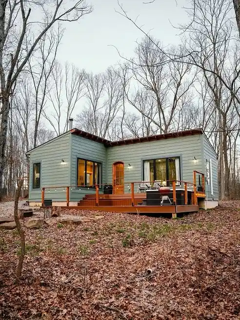 15 Tiny House Ideas for Couples Who Live Small Full-Time 16 15. Sage Blue Siding With an Arched Orange Door