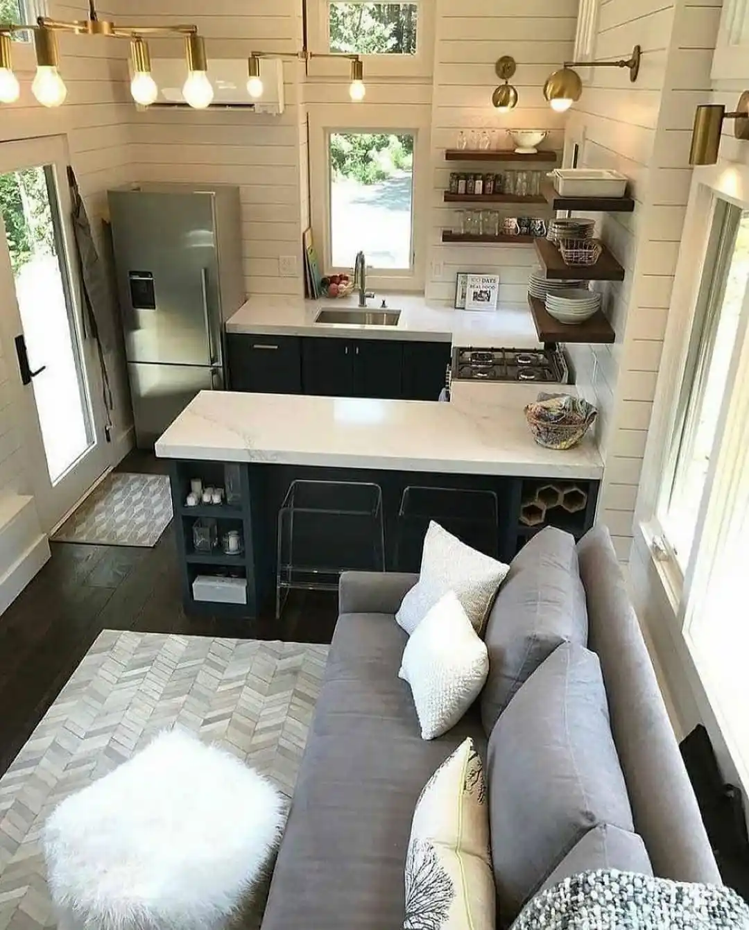 13. Brass Bulbs Over a Navy Kitchen Peninsula