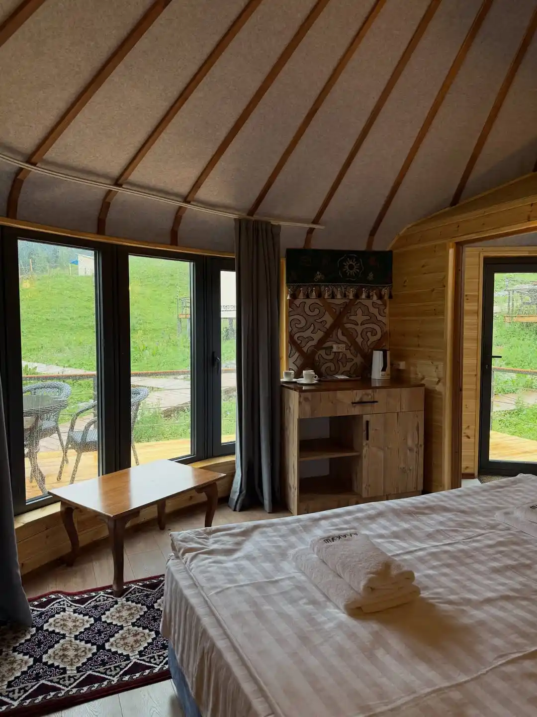 17 Yurt Living Ideas for a Cozy Off-Grid Lifestyle 17 16. A Glass Wall Bedroom With a Tea Station