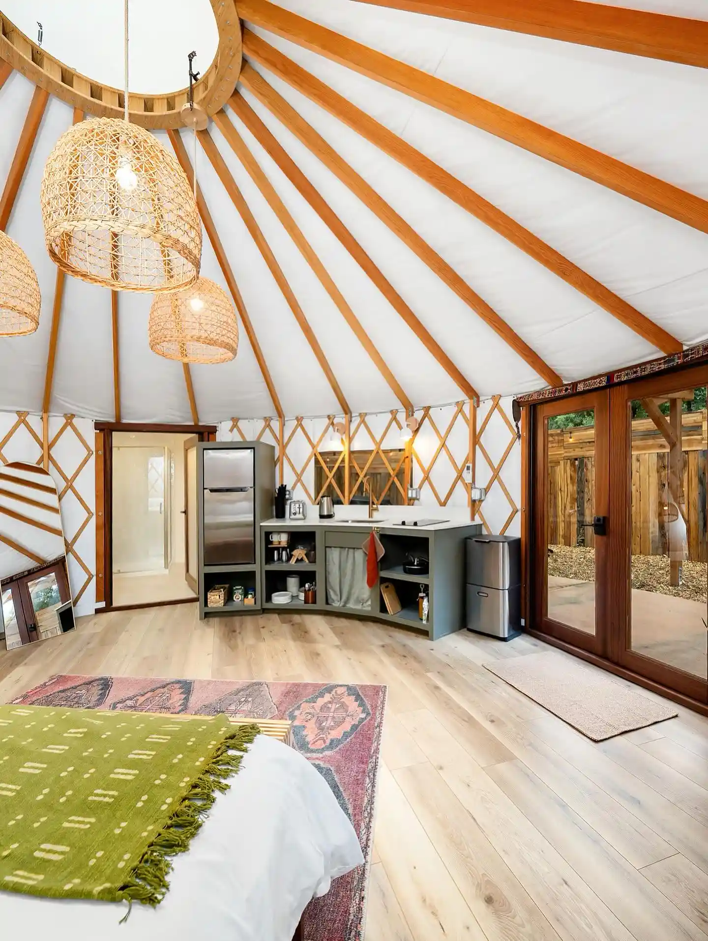 17 Yurt Living Ideas for a Cozy Off-Grid Lifestyle 2 1. A Curved Sage Kitchen Along the Lattice Wall