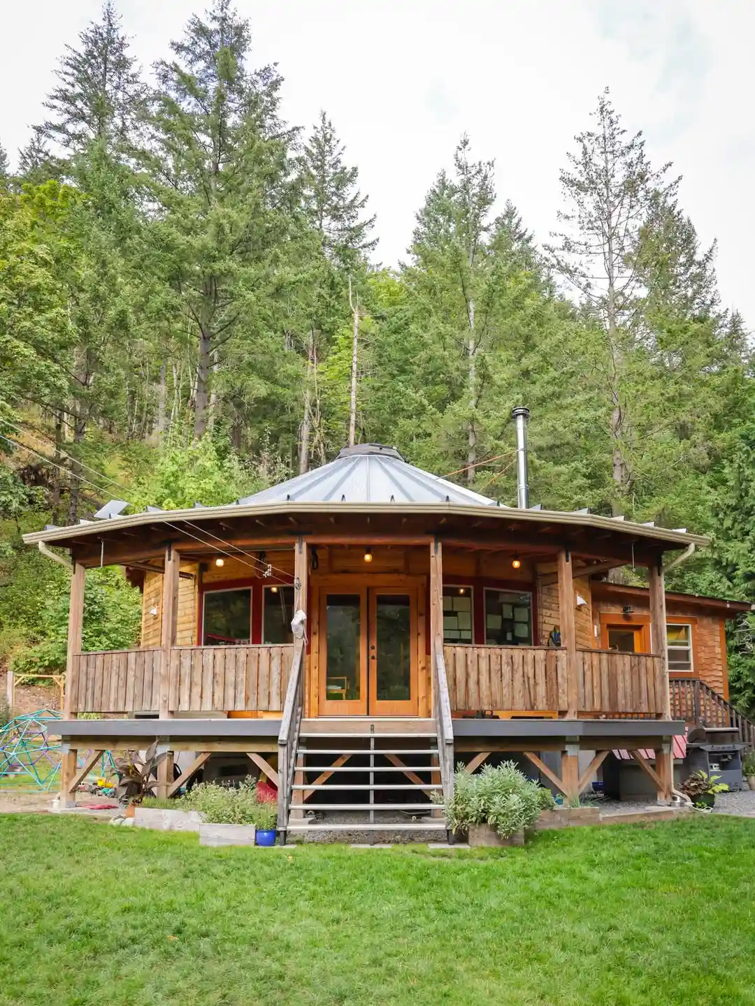 17 Yurt Living Ideas for a Cozy Off-Grid Lifestyle 6 5. A Wraparound Deck Around a Forest Yurt