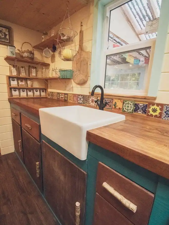 15 Tiny House Kitchen Ideas With Full-Size Function 14 Teal Cabinets With a Talavera Tile Strip