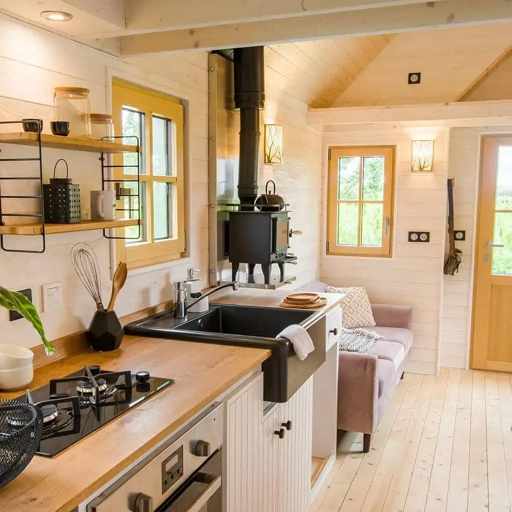 15 Tiny House Kitchen Ideas With Full-Size Function 11 Two Burner Hob and Wood Stove Combo
