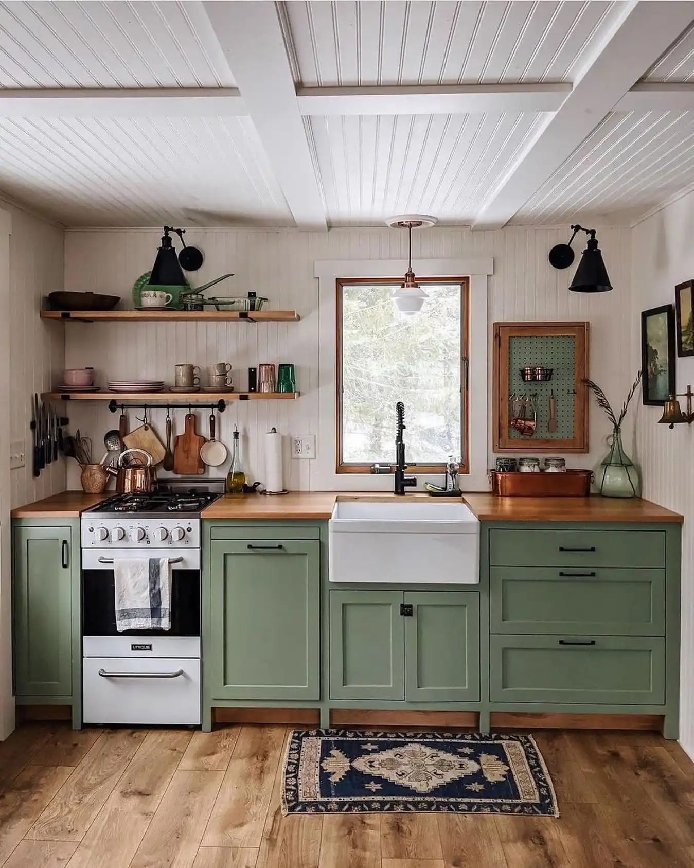 15 Tiny House Kitchen Ideas With Full-Size Function 3 Sage Shaker Cabinets With a Slim White Range