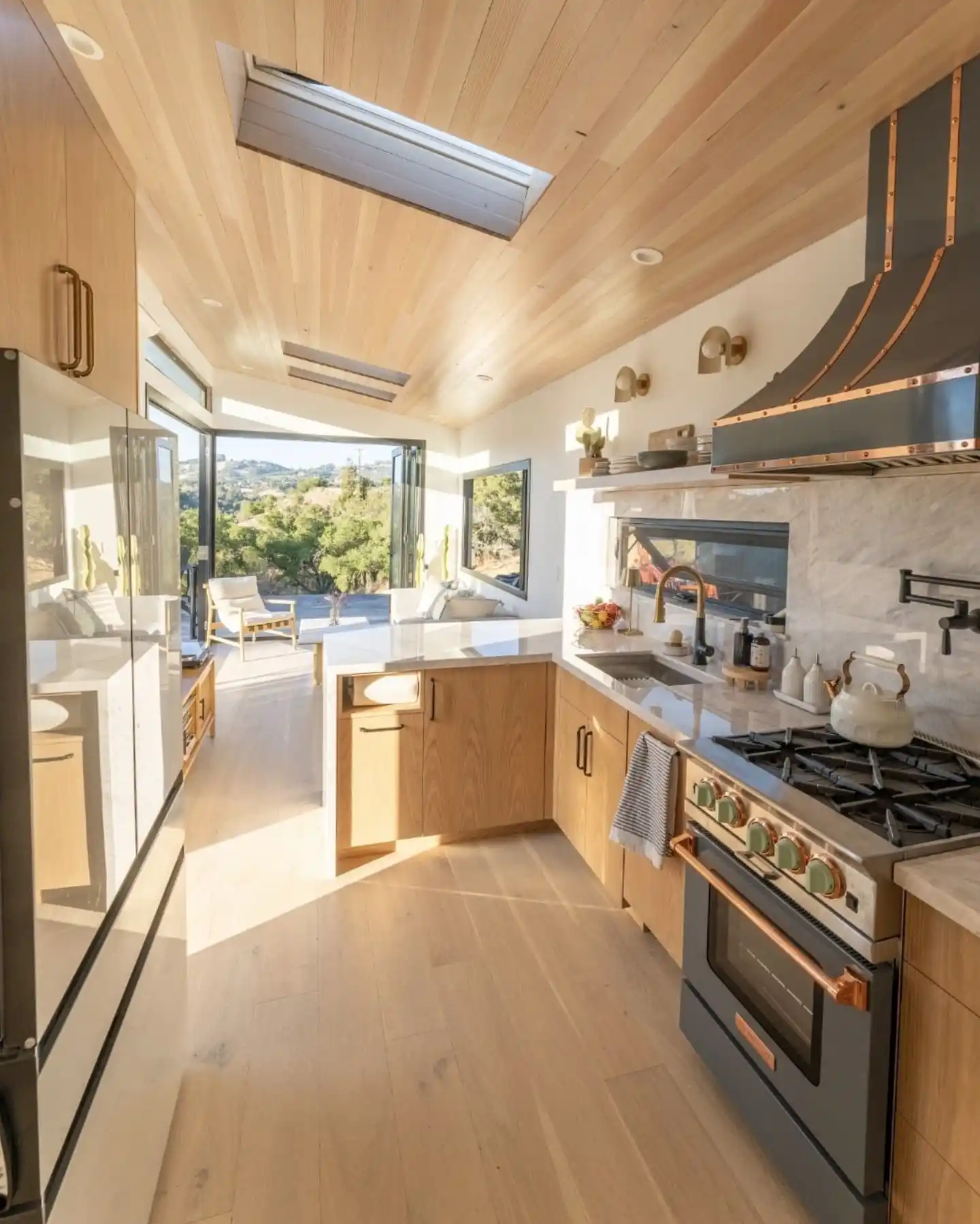 15 Tiny House Kitchen Ideas With Full-Size Function 10 Statement Range With a Copper Trimmed Hood