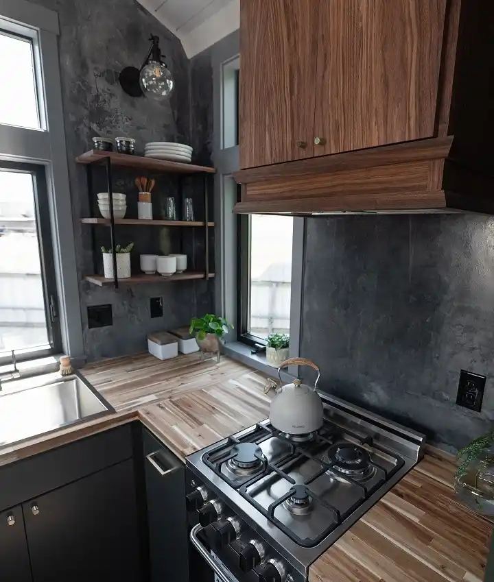 15 Tiny House Kitchen Ideas With Full-Size Function 8 Moody Charcoal Walls With a Walnut Hood Cabinet